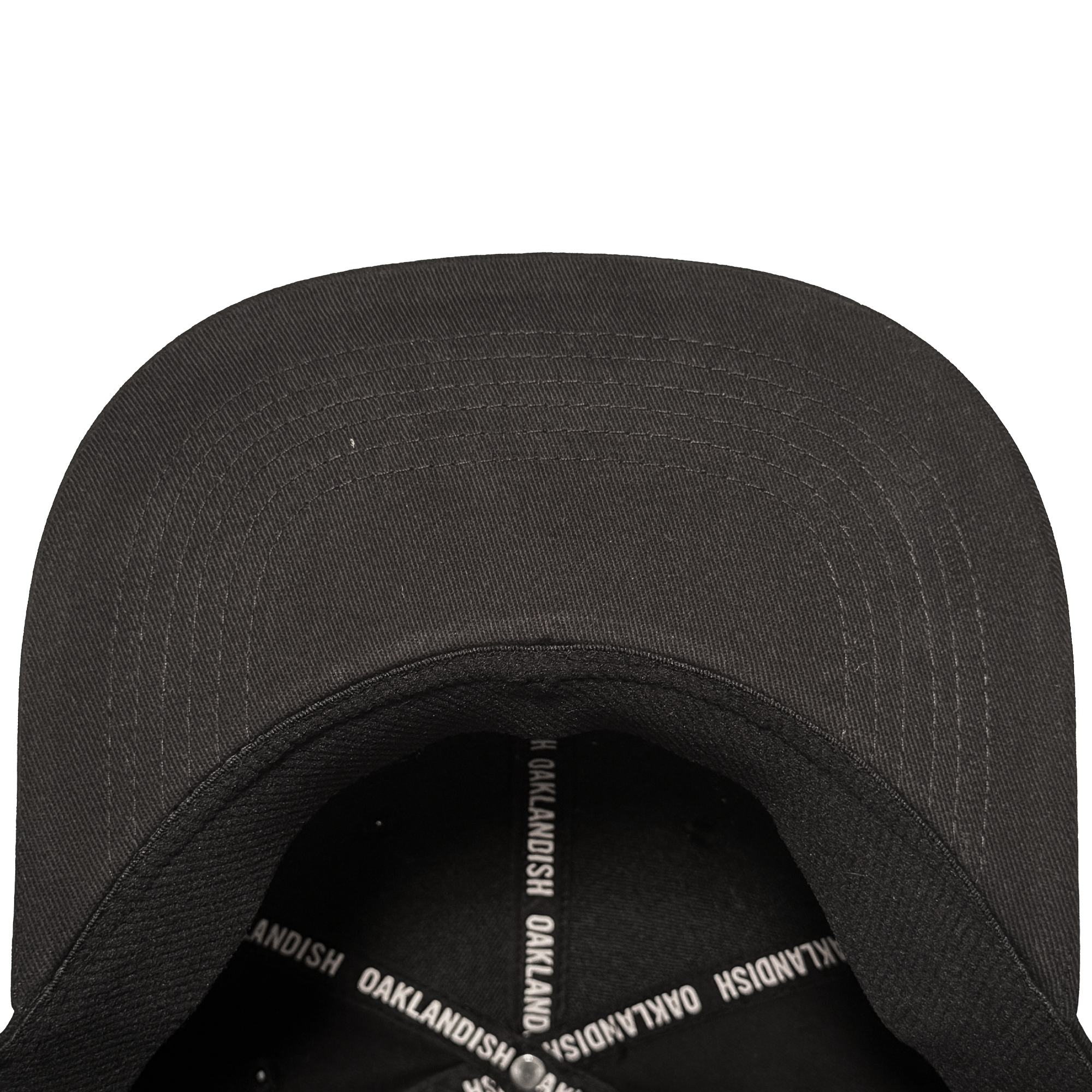 A close-up, top-down view of the Oakland Stand Up Hat by Oakland Ballers, showing its curved-brim black cap, visible stitching, and interior sweatband with crossed bands reading "OAKLANDISH," honoring Oakland’s baseball team spirit.