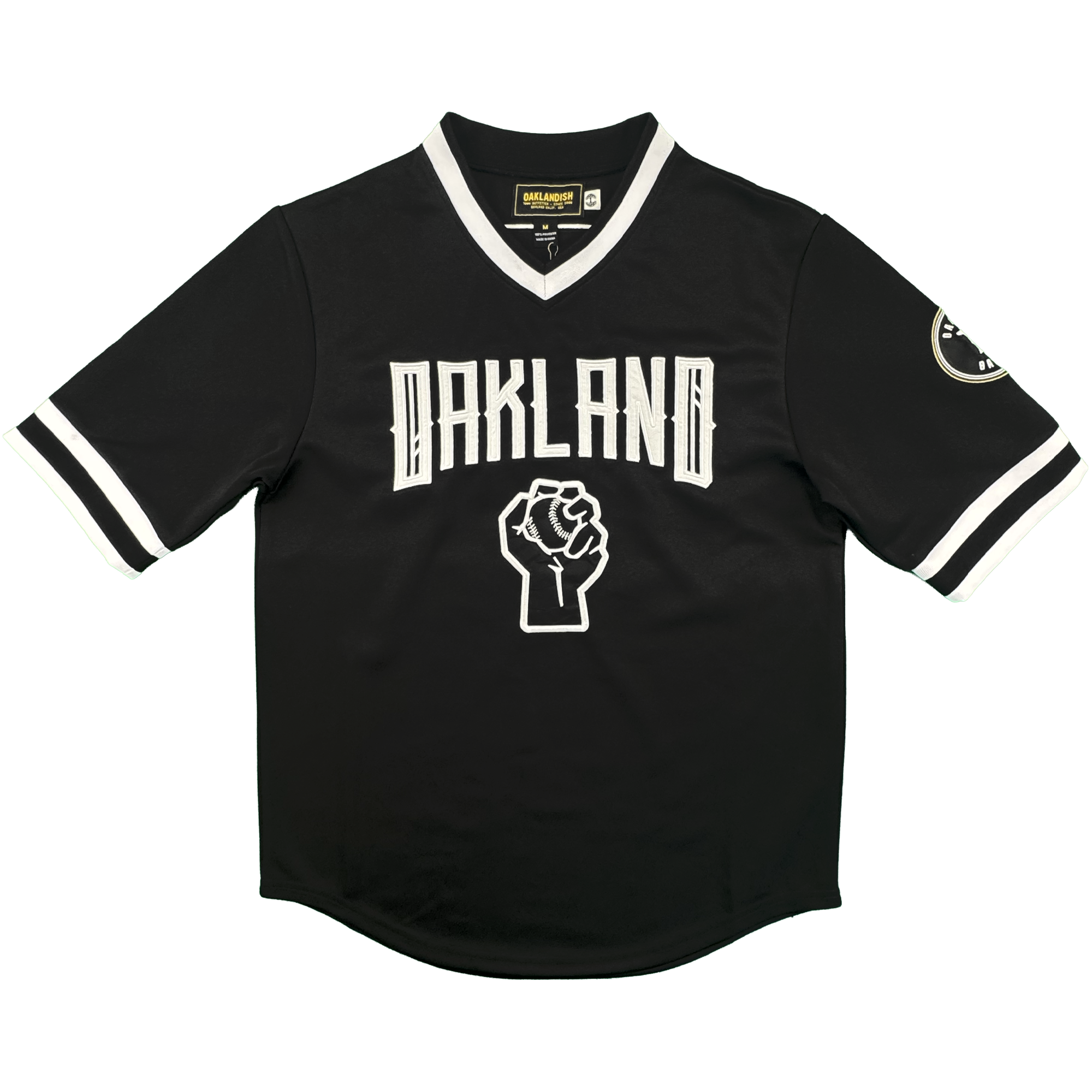 The Stands Up Jersey by Oakland Ballers is a black short-sleeve jersey with white-trimmed collar and sleeves, "OAKLAND" in bold white above a raised fist graphic, white sleeve stripes, and a circular patch on the left sleeve.