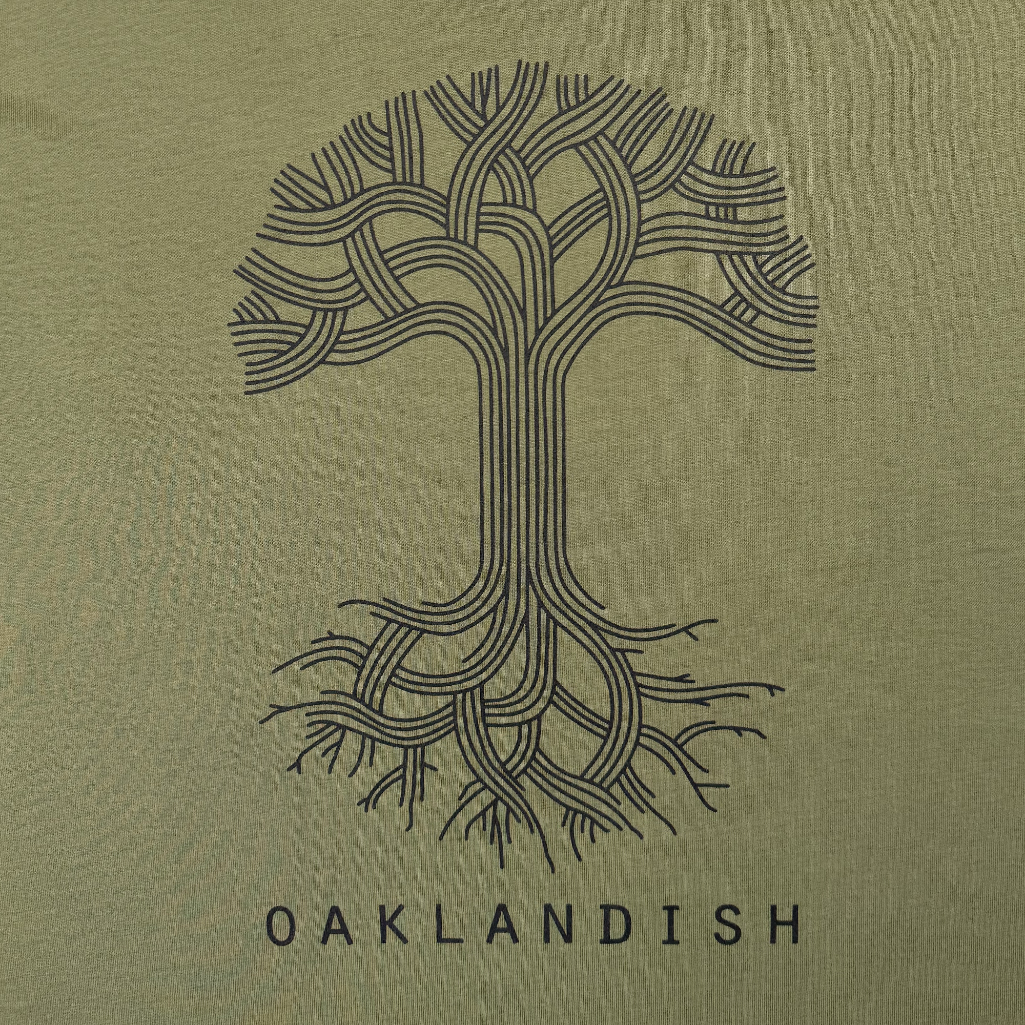 The Oaklandish Classic Logo Tee by Oaklandish features a stylized black tree with interwoven branches and roots on an olive-green background, "OAKLANDISH" below, and a minimalist geometric design on a men’s cotton T-shirt.