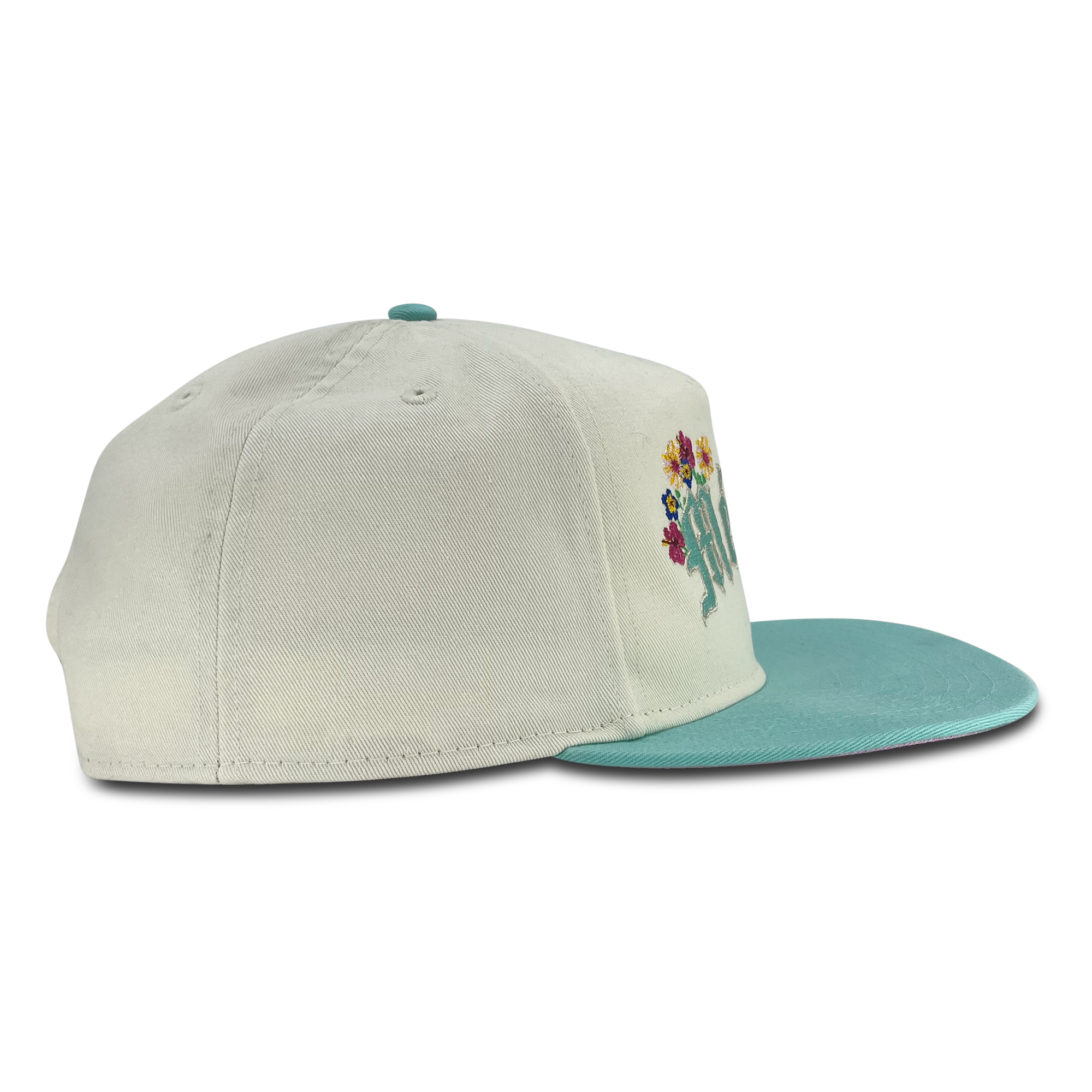 Right side view of cream New Era golfer hat with embroidered Mexico& floral design.