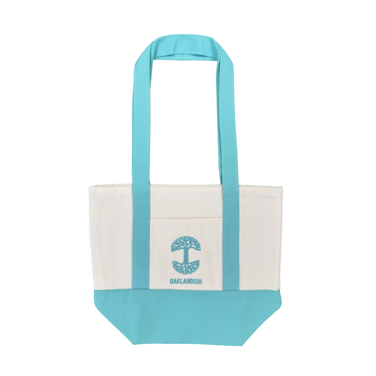Introducing the Oaklandish Mini Grocery Tote by Oaklandish—a canvas tote bag featuring aqua blue handles and bottom, a white body, and a convenient front pocket. The pocket is adorned with an embroidered aqua blue tree graphic and “OAKLANDISH” written below. Ideal for use as a mini grocery tote or carrying your everyday essentials. Shown against a plain white background.