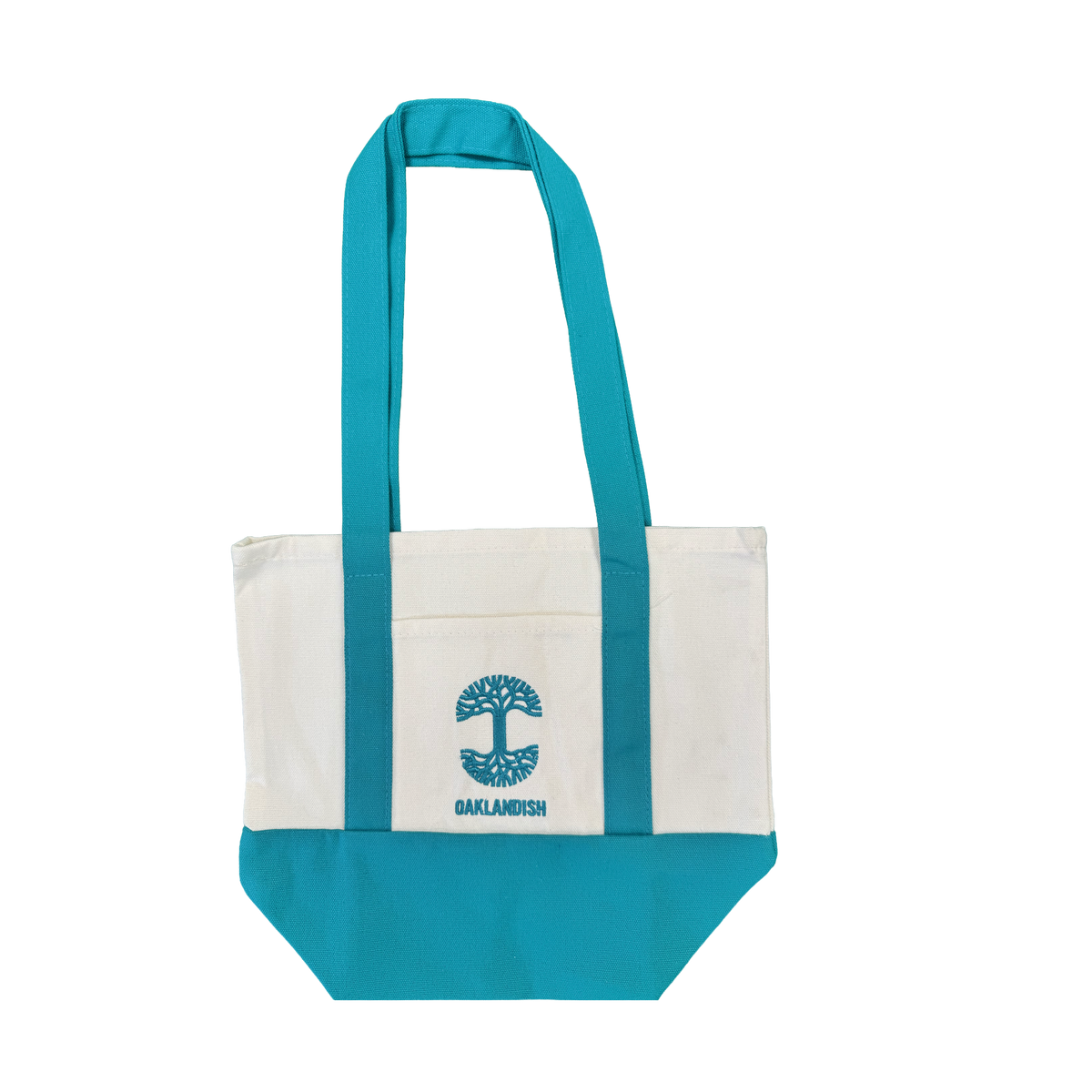 The Oaklandish Mini Grocery Tote by Oaklandish features teal blue handles and bottom with a white center. An embroidered turquoise tree logo and the word “OAKLANDISH” decorate the front pocket. The tote is shown on a plain white background.