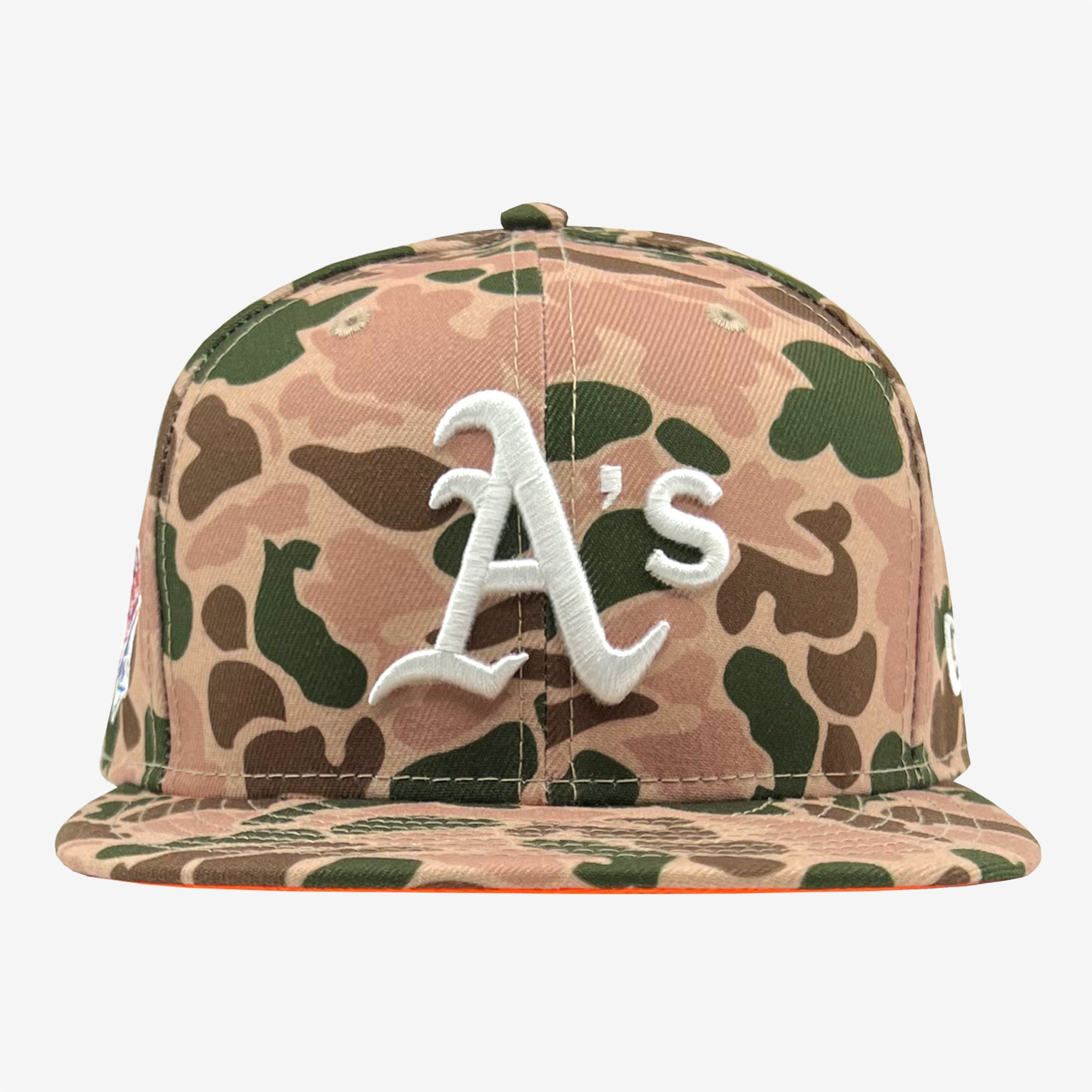 The New Era Oakland A's 59FIFTY Fitted Cap from Retail Vendors showcases a Duck Camo design with a blend of brown and green hues. The front prominently features a white, embroidered "A's" logo. Both the brim and the body display the same camouflage pattern.