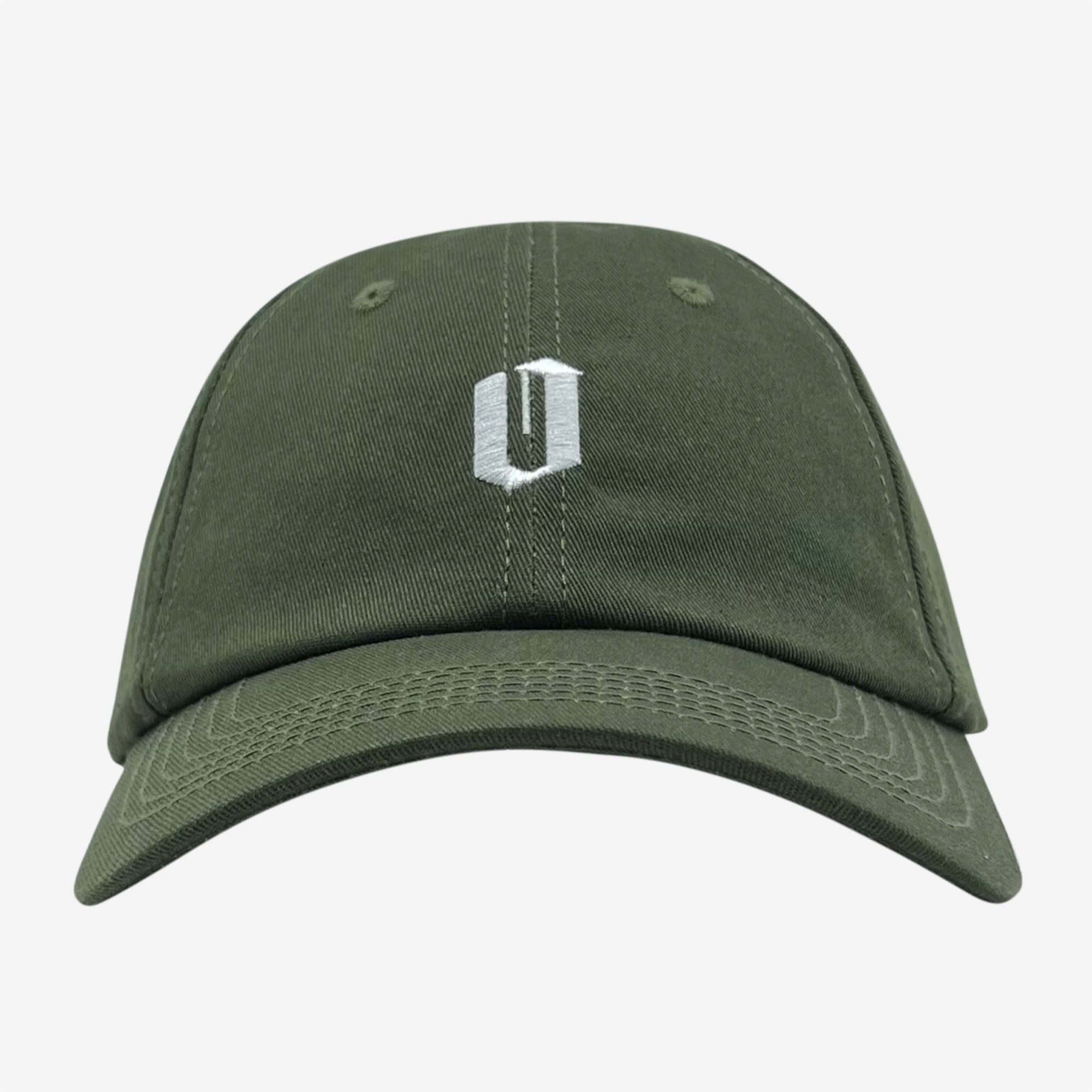 The Oaklandish Official Micro Logo Dad Hat in green is displayed against a plain white background. The cap prominently features a small white embroidered "U" logo on the front, just above the bill. Its design is minimalist, showcasing a curved brim, visible stitching along the panels and edges, and an adjustable strap for an ideal fit.