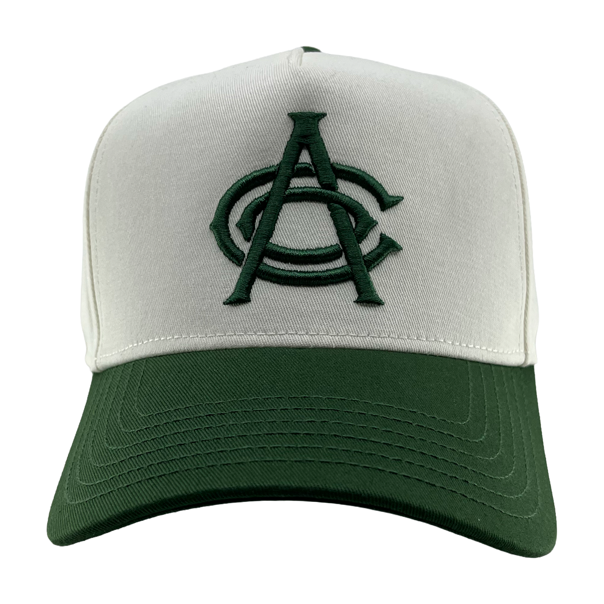 The OAC Logo 5 Panel by OAC is a baseball snapback cap featuring a white front panel and a green bill. The cap displays an embroidered green Oakland Athletic Club logo with two overlapping letters, “A” and “C,” on the front. The background is plain white.