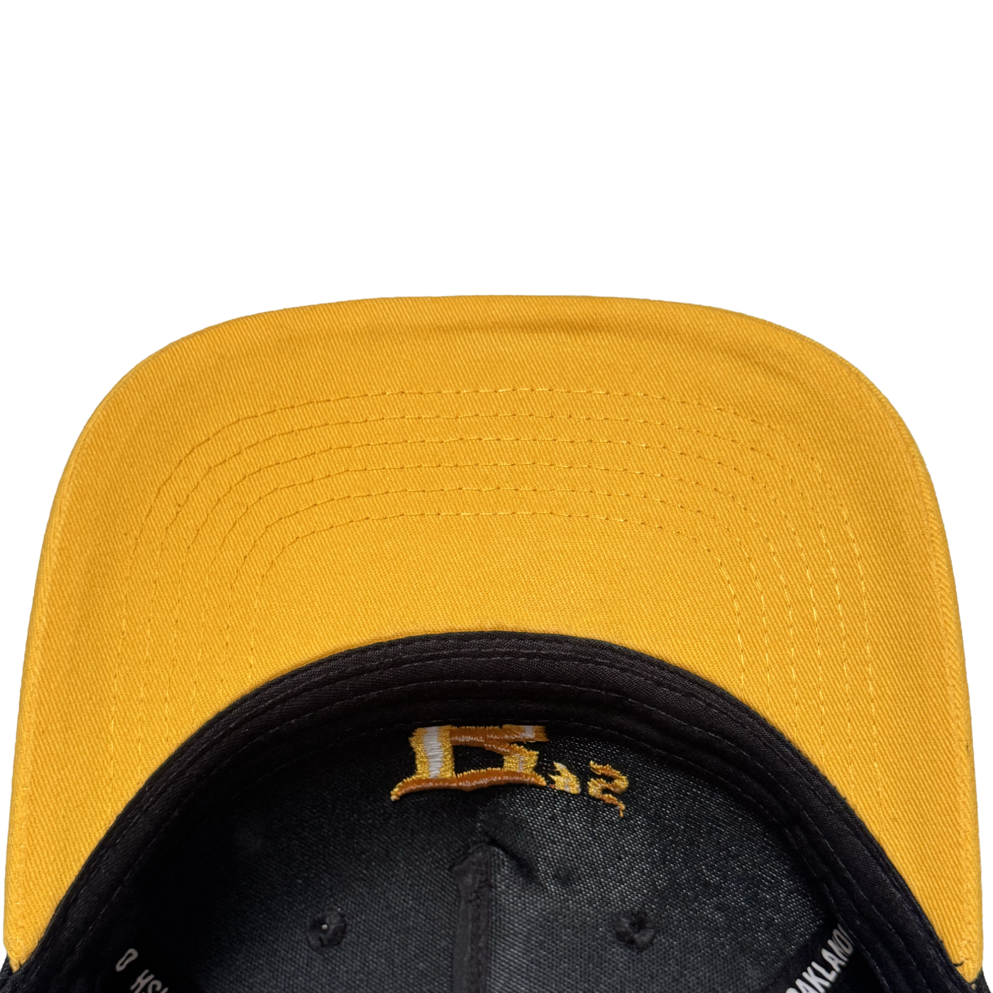 A close-up, top-down view of the Oakland Ballers 5 Panel Cap shows its yellow stitched brim and black underside with a gold embroidered "E" and "32," all set against a plain white background—a tribute to the Oakland Ballers spirit.