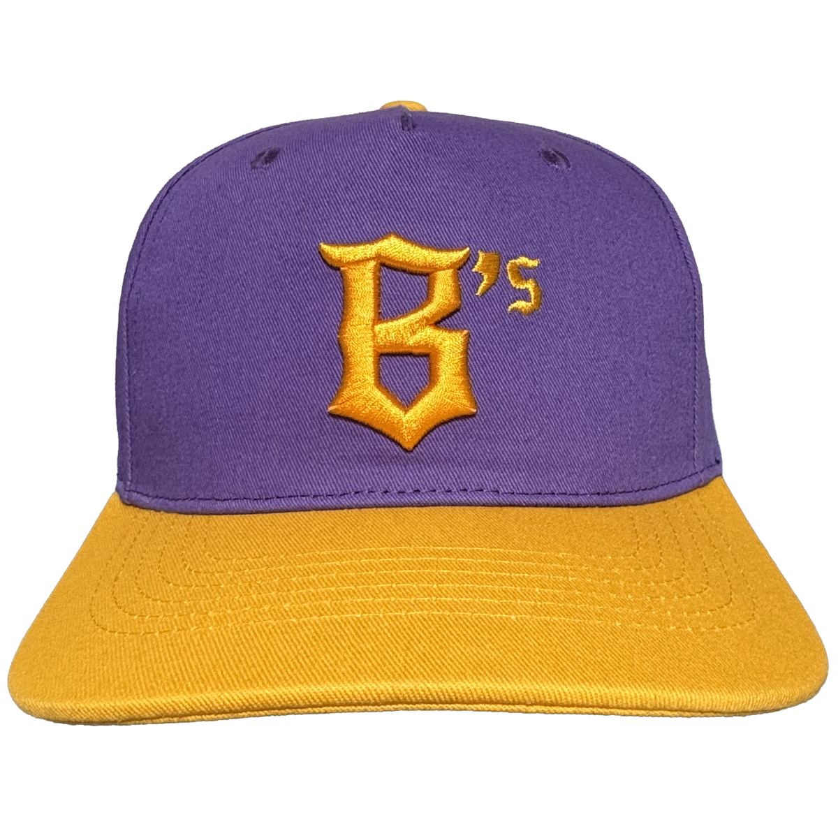 The Oakland Ballers 5 Panel Cap by Oakland Ballers features a stylish purple snapback design with a flat gold brim. On the front, it showcases a prominent gold letter “B” with an embroidered gold “’s” in the top right corner, both in a distinctive font that pays homage to the Oakland Ballers. The cap is finished with two small black ventilation holes on top, blending comfort and style—perfect for any fan of Oakland’s baseball team.