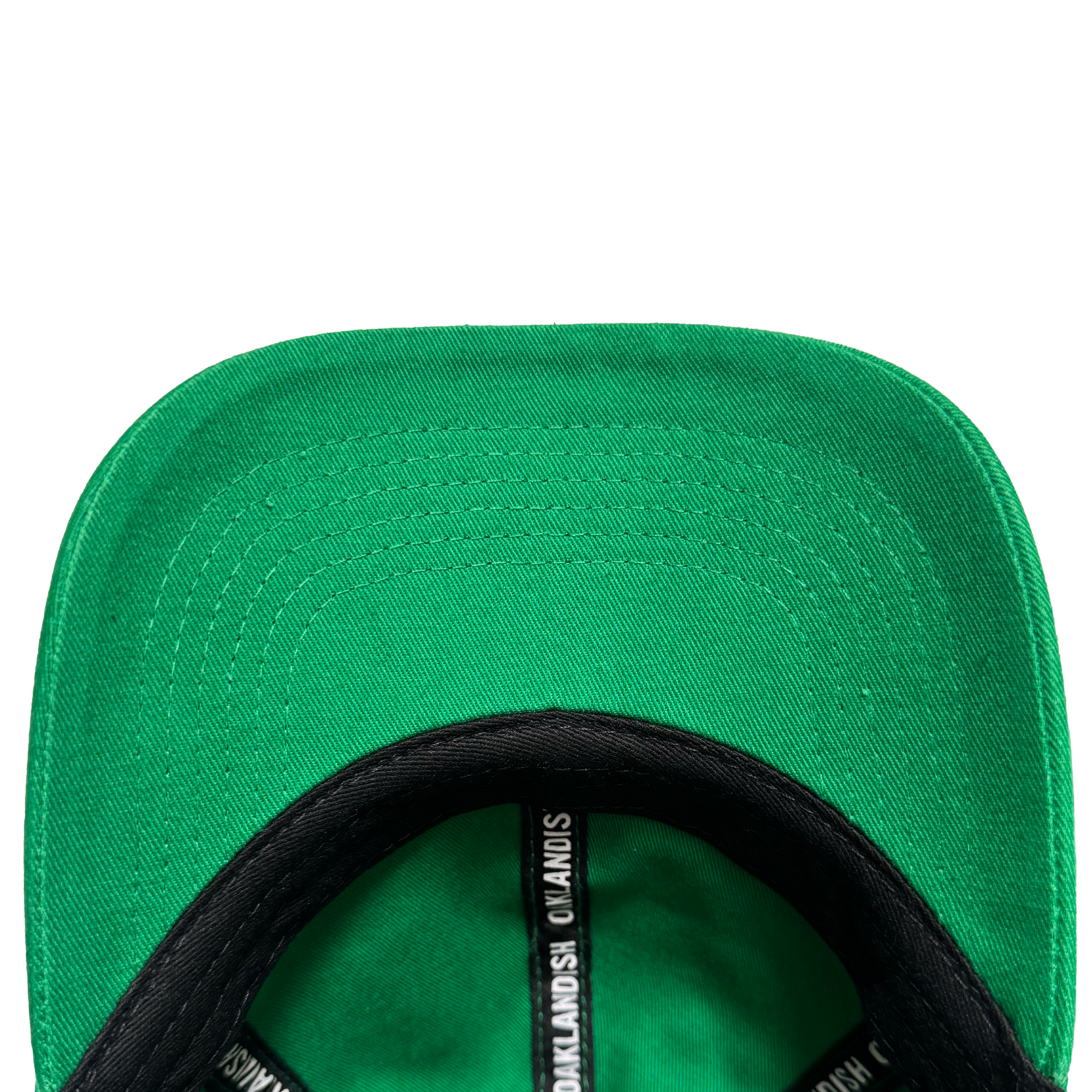 Close-up of the underside of the Oakland Ballers Dad Hat brim, highlighting detailed stitching. The black inner band displays white repeating text: "Oakland Ballers," echoing the brand's iconic style. Set against a plain white background.