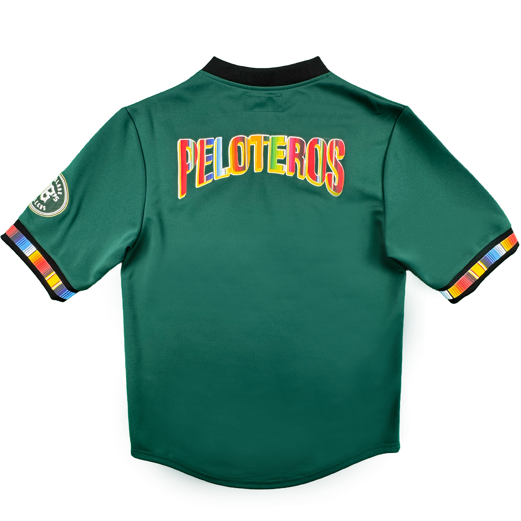 The Peloteros Jersey by Oakland Ballers features a vibrant green design, showcased from the back with “PELOTEROS” boldly displayed in rainbow-colored letters—a tribute to the team’s lively spirit. Multicolored stripes accent the sleeve cuffs, accompanied by a circular patch on the left sleeve that honors their Pioneer League heritage. The black collar stands out against a plain white background.