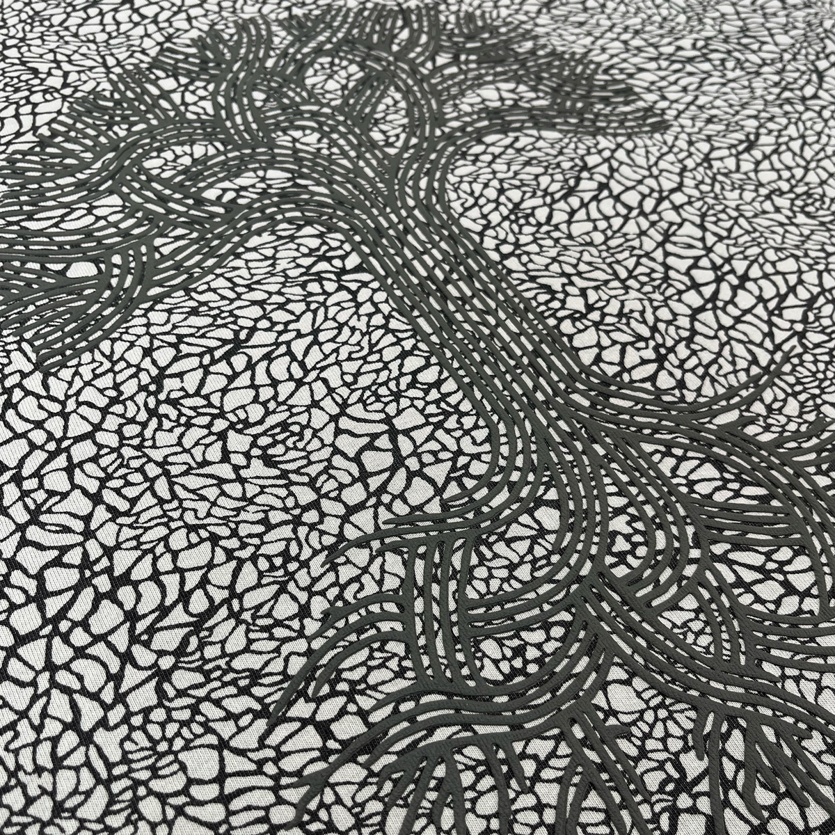 With bold black lines weaving across a white background, the Oaklandish Classic Logo Tee by Oaklandish features a puff print design reminiscent of tangled roots or veins—thick curves intersecting a web of fine, irregular cracks for an organic sense of movement and complexity. Crafted on heavyweight cotton in a classic fit, this striking t-shirt melds artistic flair with everyday comfort.