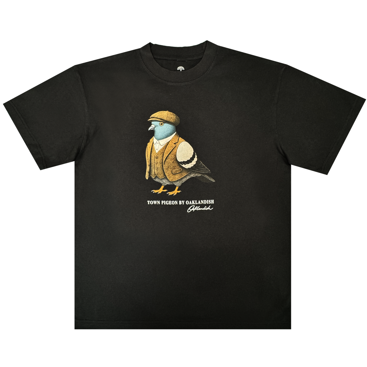 Introducing the Dapper Tee from Oaklandish’s men’s collection—a black classic fit t-shirt showcasing a graphic of a pigeon dressed in a brown flat cap and vest. Underneath the illustration, “TOWN PIGEON BY OAKLANDISH” is printed in white text with a distinctive signature-like flourish below. Crafted from heavy-weight cotton, this standout tee is set against a plain white background.