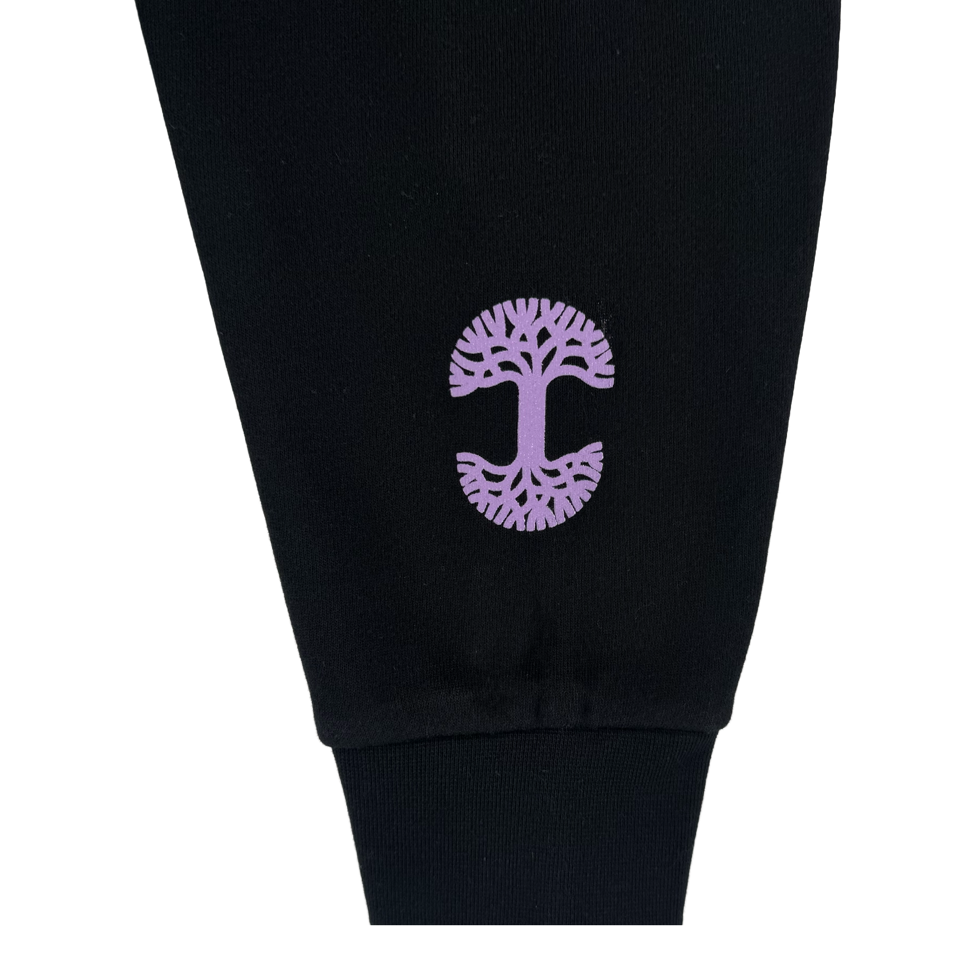 A close-up of a black pant leg shows a purple tree graphic with intricate branches and roots near the cuff. Pair it perfectly with the GSV Renowned Hoodie by GSV. The photo has a plain white background.