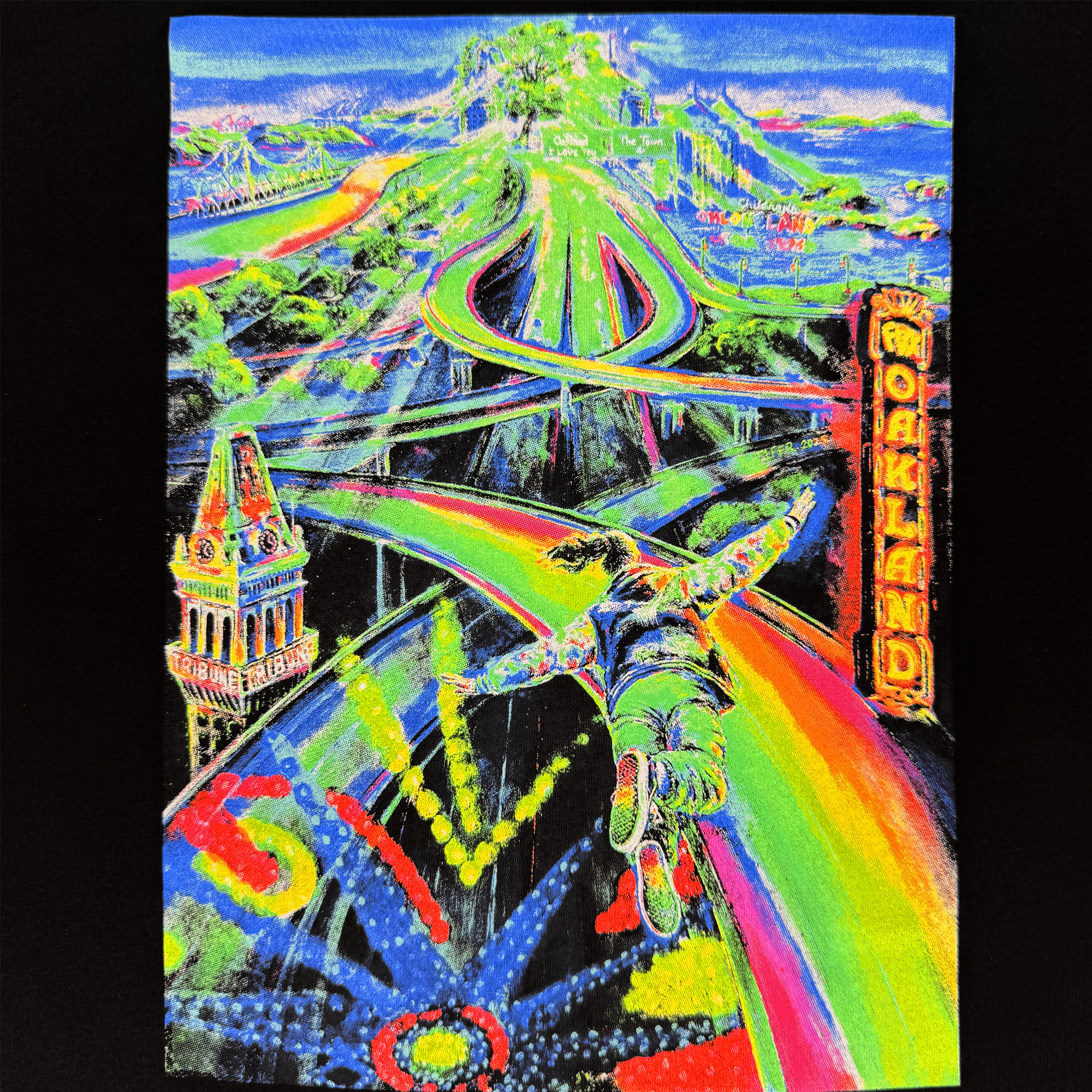 The Women's Yay Area Tee by Oaklandish features vibrant neon art of a figure soaring over a surreal Oakland cityscape, with winding rainbow paths crossing lush hills and iconic landmarks in the background.