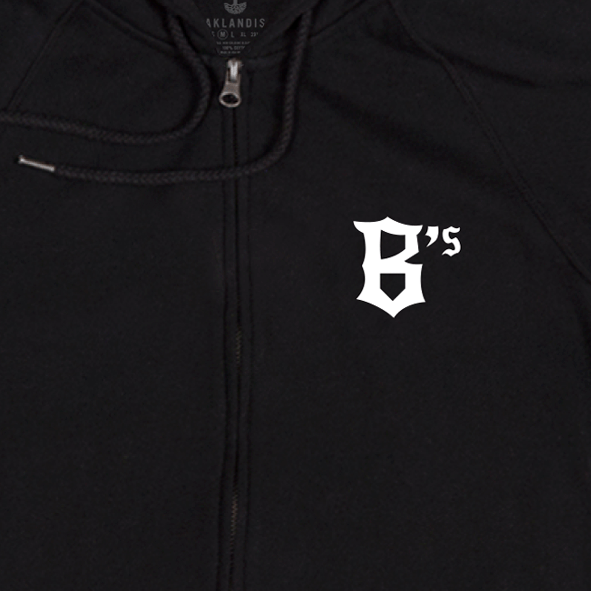 Introducing the Oakland Ballers Logo Zip by Oakland Ballers—a black zip-up hoodie featuring a white, Old English-style "B's" logo on the left chest, celebrating Oakland’s new Pioneer League baseball team. The design includes a visible drawstring near the zipper and a subtle "OAKLANDISH" tag at the collar.