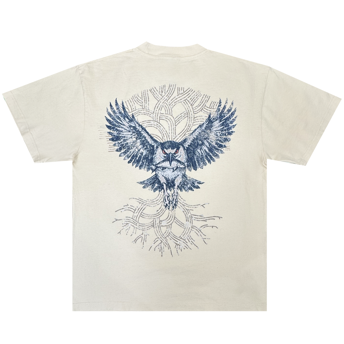 The Oaklandish Swoop Tee is a cream-colored, heavyweight cotton men’s t-shirt featuring a bold blue owl graphic with outstretched wings on the back. Abstract, tree-like branches form a circular pattern behind the owl, adding depth to the layered design on this classic fit tee.