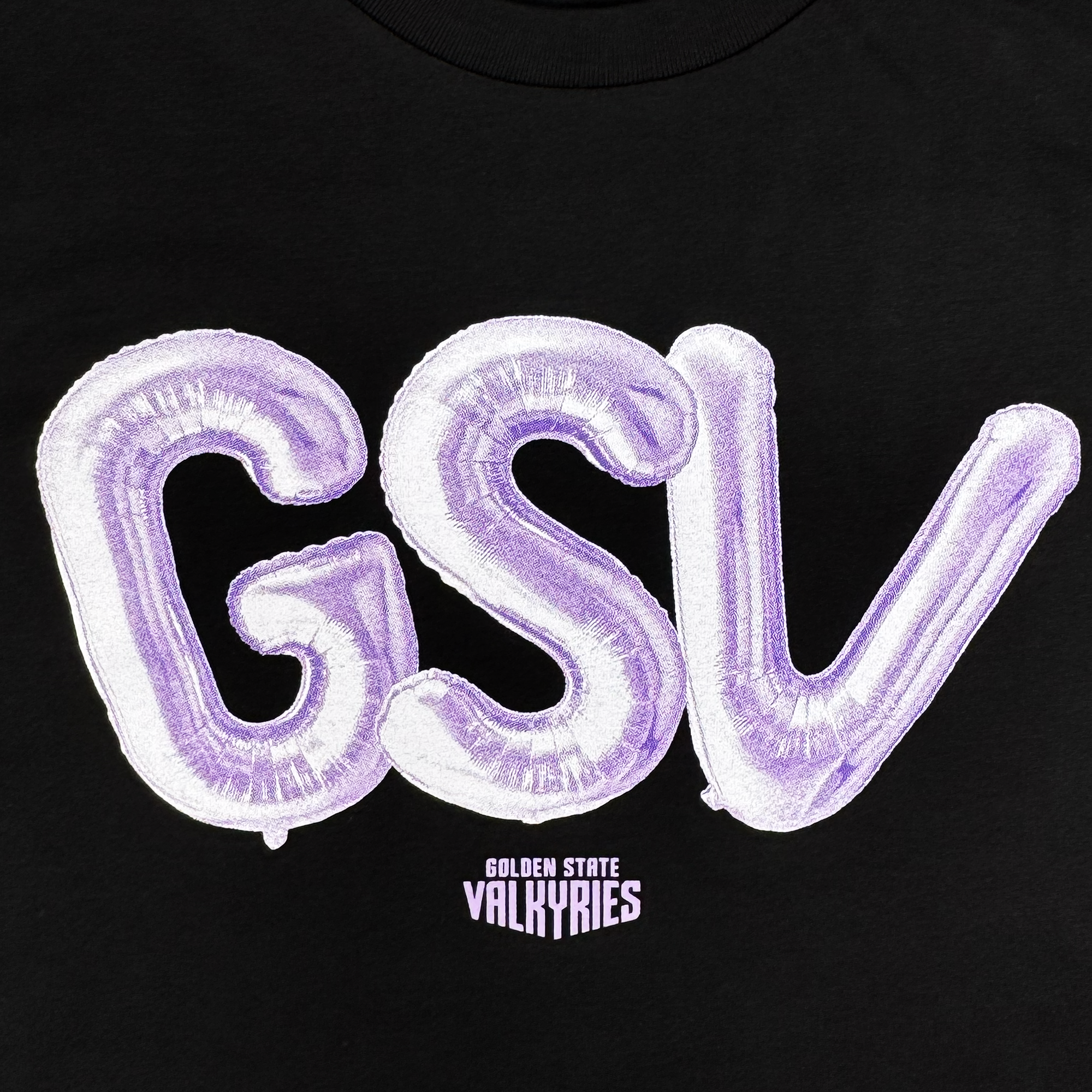The Women's Golden State Valkyries Balloons Crop Tee by GSV features large, shiny purple balloon letters spelling "GSV" on black, with “Golden State Valkyries” below—an eye-catching, playful design perfect for cropped women’s tees.